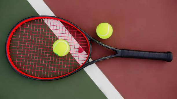 istock Tennis racket with balls on green and red background 1070743498