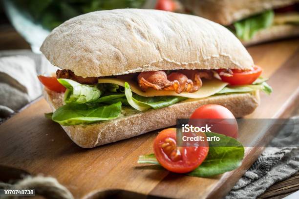 Ciabatta Sandwich With Arugula Salad Bacon And Yellow Cheese Stock Photo - Download Image Now