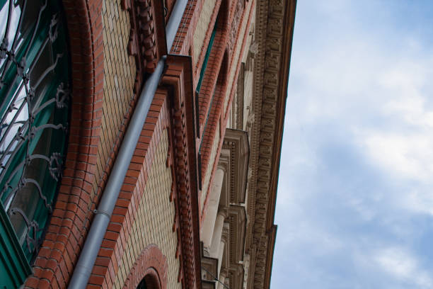 istock Detailed view of a building front with old-fashioned archway, window floor, bricks and bricks and downpour 1070753150