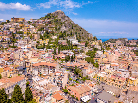 Aerial view of the Duomo in most popular Sicilian resort Taormina. Townscape of Taormina with cathedral, square and the hill with other buildings.