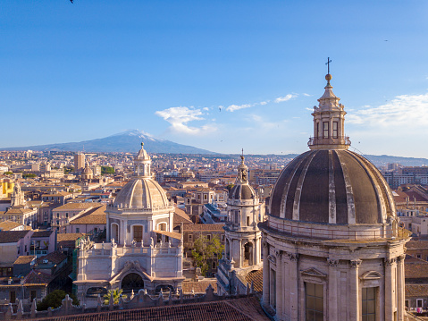 Beautiful aerial view of the Catania city near the main Cathedral and Etna volcano on the background. Amazing old town view from above.