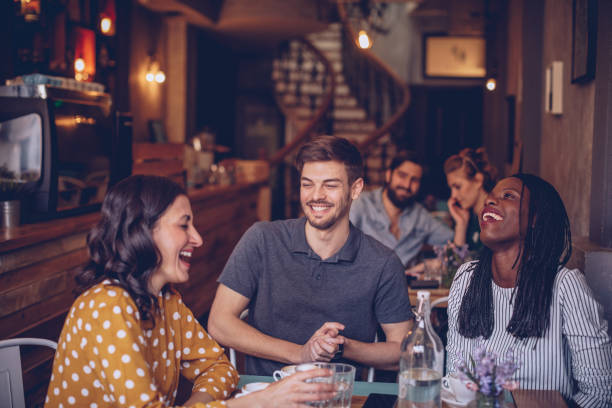 istock Happy young friends at coffee shop 1070759566