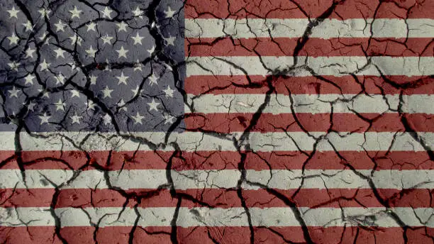 Political Crisis Or Environmental Concept: Mud Cracks With US Flag