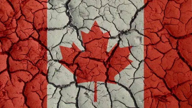 Political Crisis Or Environmental Concept: Mud Cracks With Canada Flag
