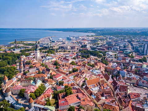 Amazing aerial view of the Tallinn old town with many old houses sea on the horizon.