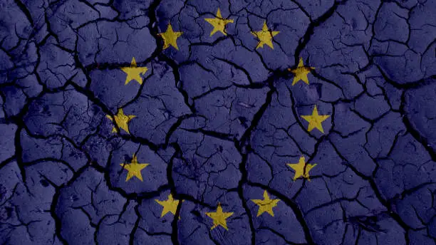 Political Crisis Or Environmental Concept: Mud Cracks With EU Flag