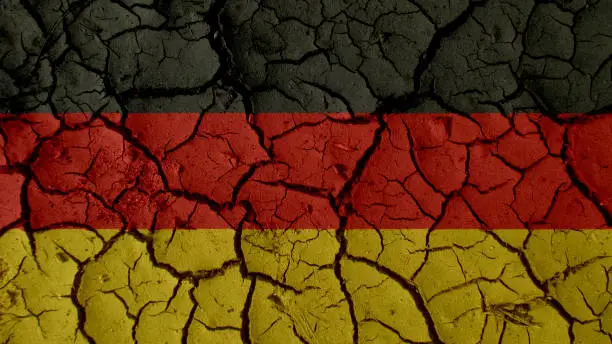Political Crisis Or Environmental Concept: Mud Cracks With Germany Flag