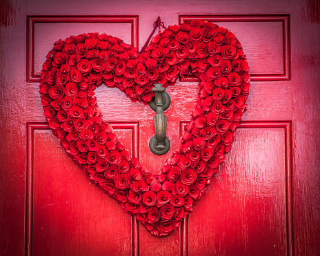 Red rose heart wreath on a red door in old town Alexandria Virginia for Valentines Day
