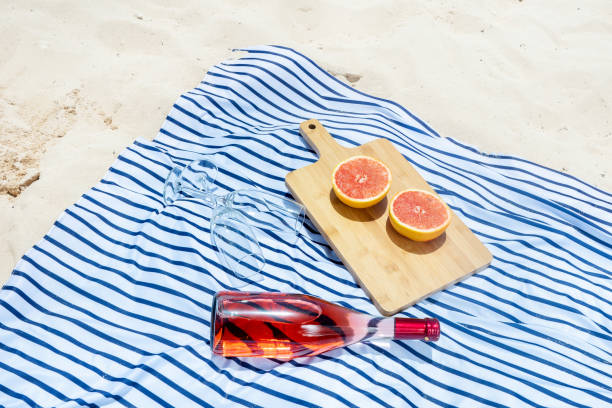 istock Beach picnic with wine and grapefruit 1070766646