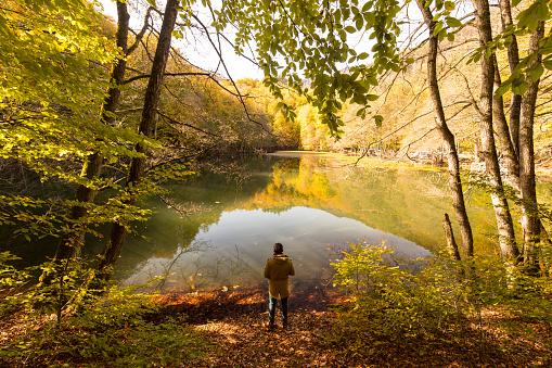 Man and nature in autumn time - Forest, river, lake