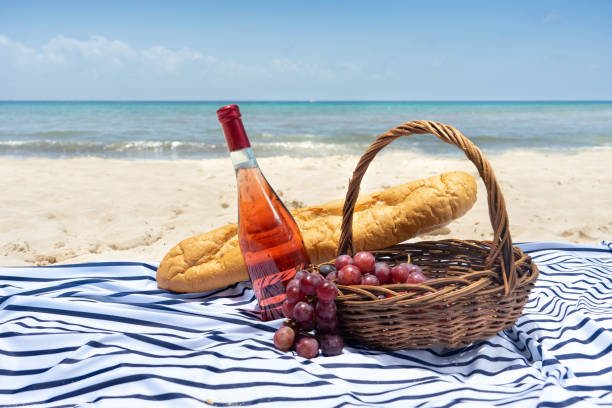 istock Beach picnic with wine, baguette bread and grapes 1070772630