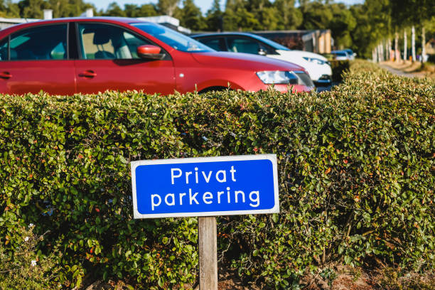 Blue colored sign with information in Swedish PRIVAT PARKERING at the entrance of car park stock photo