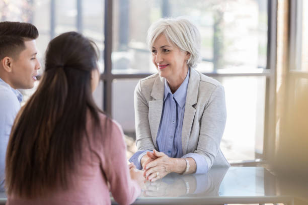 istock Confident marriage counselor talks with young couple 1070775038