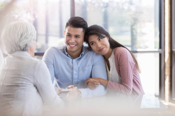 istock Happy young couple talk with counselor 1070775044