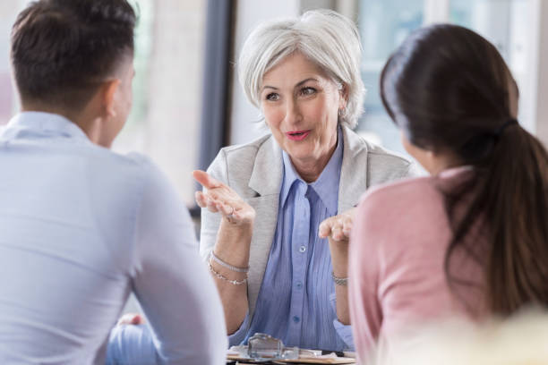 istock Female counselor talks with young couple 1070775064
