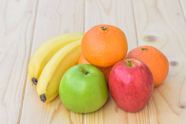istock Healthy Fresh fruits (Banana, Orange, Apple) on wood table 1070778404