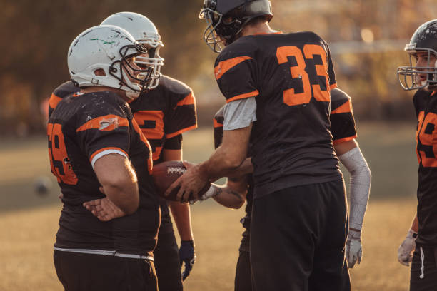 istock Football players playing a match 1070781728