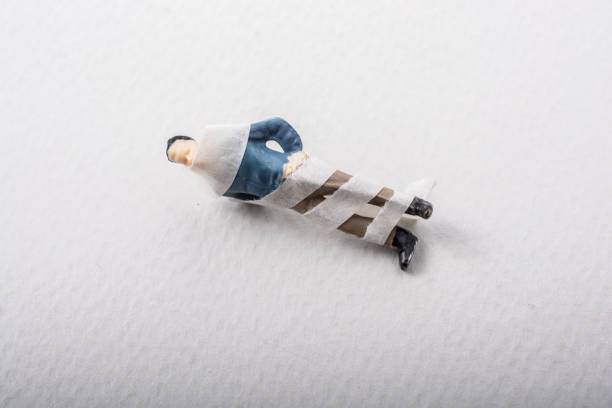 Tiny figurine of man miniature model wrapped in bandages