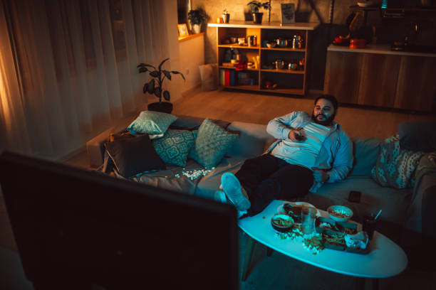 istock Overweight man watching TV 1070795438