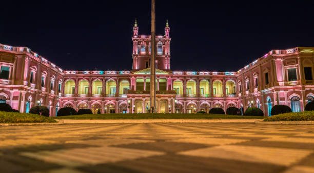 View on illuminated pink presidential palace in Asuncion, Paraguay at night stock photo