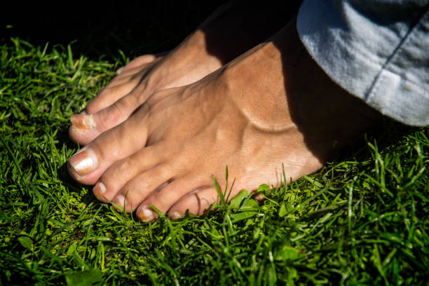 istock Human Bare Feet In The Grass 1070816494