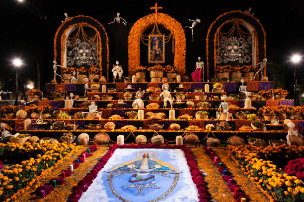 Elaborate Altar in the Zócalo for the Día de los Muertos Festival in Oaxaca, Mexico An elaborate altar in the zócalo (city square) constructed for the Día de los Muertos Festival in Oaxaca, Mexico.

(Resubmission note:  Altars like this are temporary structures built by the thousands all over Mexico for the Day of the Dead festival in homes and public places. They often contain bread, fruit, prepared food, flowers, and other perishable items.  They are taken down and the perishable items are consumed or disposed of immediately after the conclusion of the festival.  This one is vary elaborate since it was built in the zócalo of downtown Oaxaca, but it was dismantled by November 3, 2018.  Something entirely different will be built next year. Suggesting that these displays would be copyrighted would be like supposing a bunch of flowers at a grave would be copyrighted). altar stock pictures, royalty-free photos & images