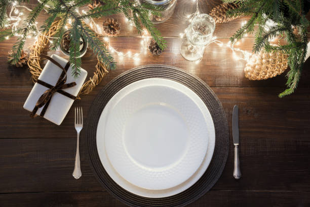 istock Christmas table setting with silverware, garland and dark decor. Top view. Xmas Party. Magic night. 1070843510