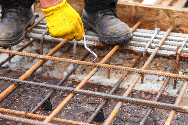 istock Worker ties steel reinforcing bars with wire. 1070845802