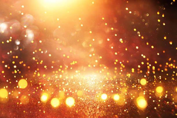 istock glitter vintage lights background. black and gold. de-focused. 1070849810