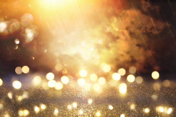 istock glitter vintage lights background. black and gold. de-focused. 1070849820