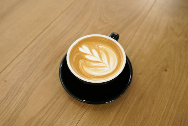 istock Flower pattern latte art on hot coffee latte serving on black cup 1070850638