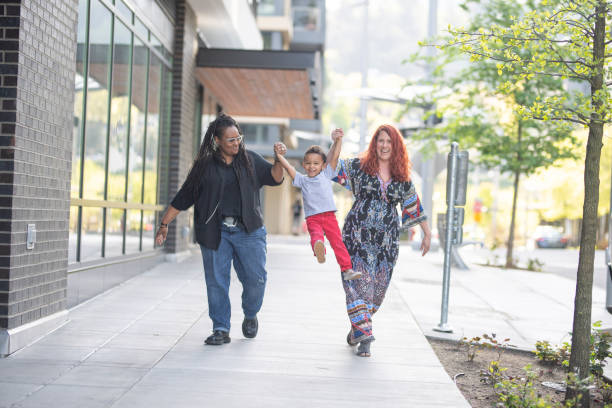istock Female couple walking with their son 1070852306