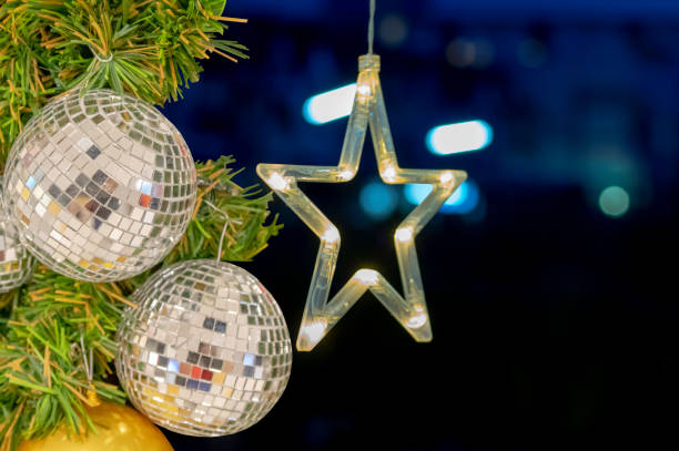 istock Glass ball ornaments on a Christmas tree and blurred lights. 1070854870
