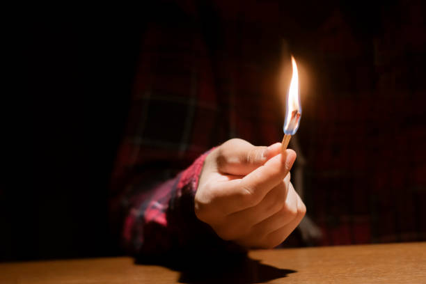 istock huge massive fire and burning match in hands in the dark f 1070855350
