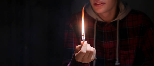 istock huge massive fire and burning match in hands in the dark f 1070855356