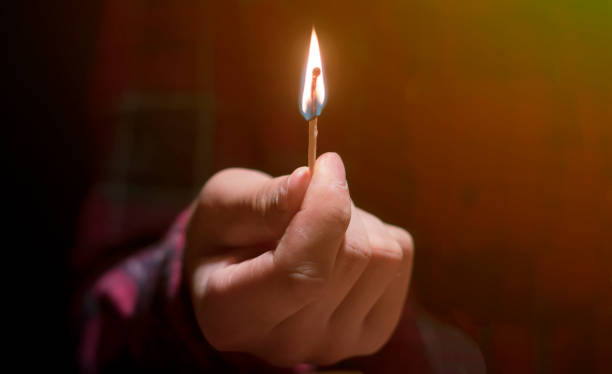 istock huge massive fire and burning match in hands in the dark f 1070855374