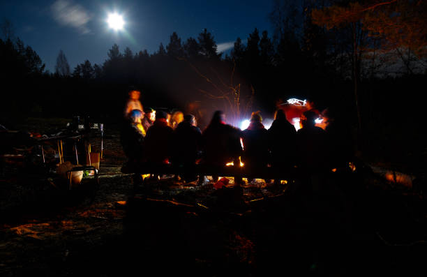 istock People sit at night round bright bonfire 1070855578