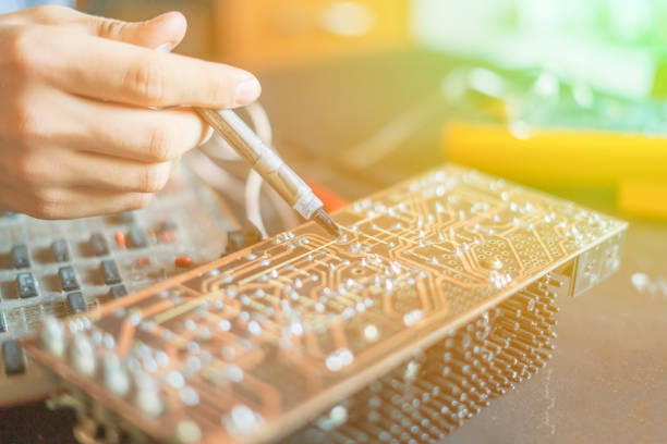 hands holding syringe and repair computer board chip