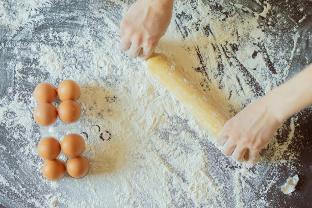 istock chef cook holding egg and preparing dough on the table top view f 1070856148