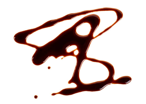 istock Liquid chocolate isolated on white background. Abstract pattern made of chocolate. 1070860092