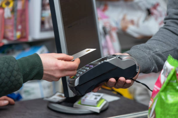 istock NFC technology, customer do payment with contactless credit card. Credit card reader implements payment execution 1070866052