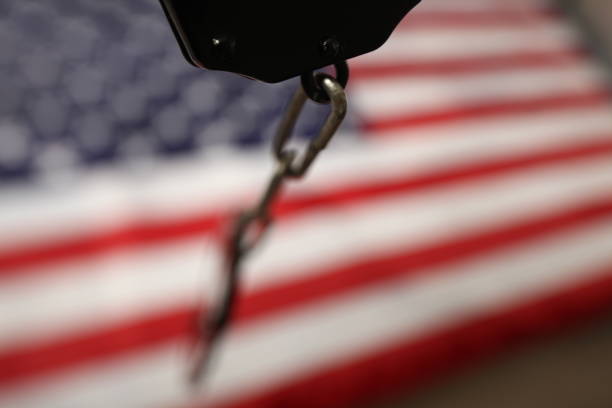 istock handcuffs on the background of the US flag 1070866534