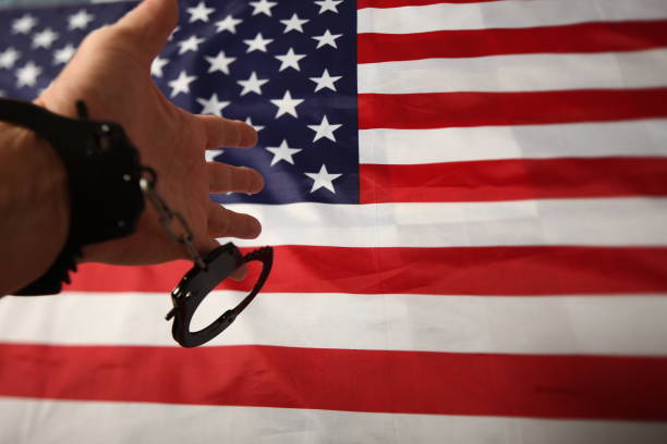 istock handcuffs on the background of the US flag 1070866536