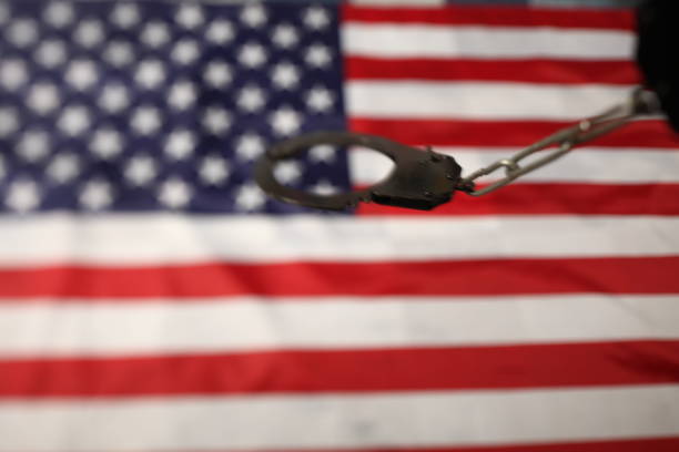istock handcuffs on the background of the US flag 1070866546