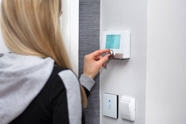 istock Girl adjusts and regulate the room temperature on smart switch 1070869052