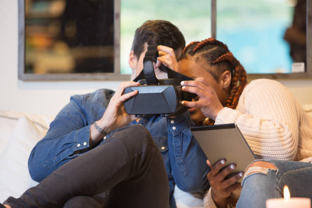istock Young couple enjoy virtual reality at home 1070869388