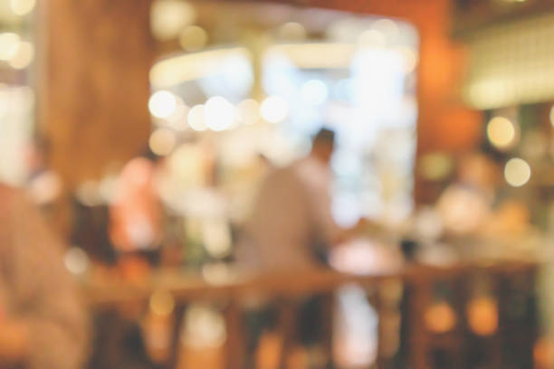 istock Restaurant cafe or coffee shop interior with customer blur abstract vintage style bokeh light for montage product display background 1070871680