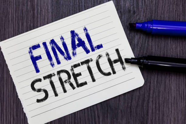 istock Writing note showing Final Stretch. Business photo showcasing Last Leg Concluding Round Ultimate Stage Finale Year ender Notebook Paper Reminder Communicating ideas Markers Wooden background. 1070872180
