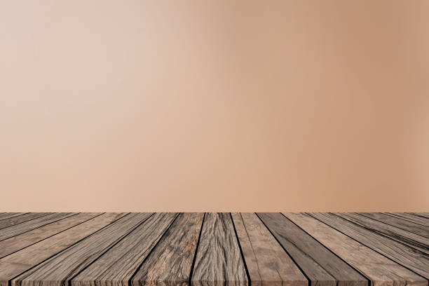 istock abstract blur smooth tan color background with shiny light effect and vintage retro brown wood table top for show ,promote , advertise on display , simple montage image concept 1070877178