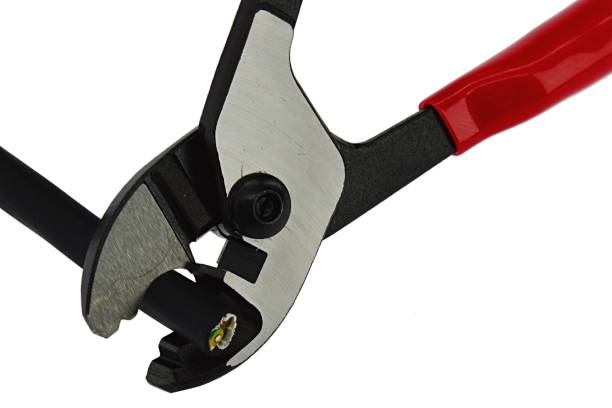 istock Combined wire cutting pliers with black rubber insulated three-core cable in opened jaws, white background. 1070883060